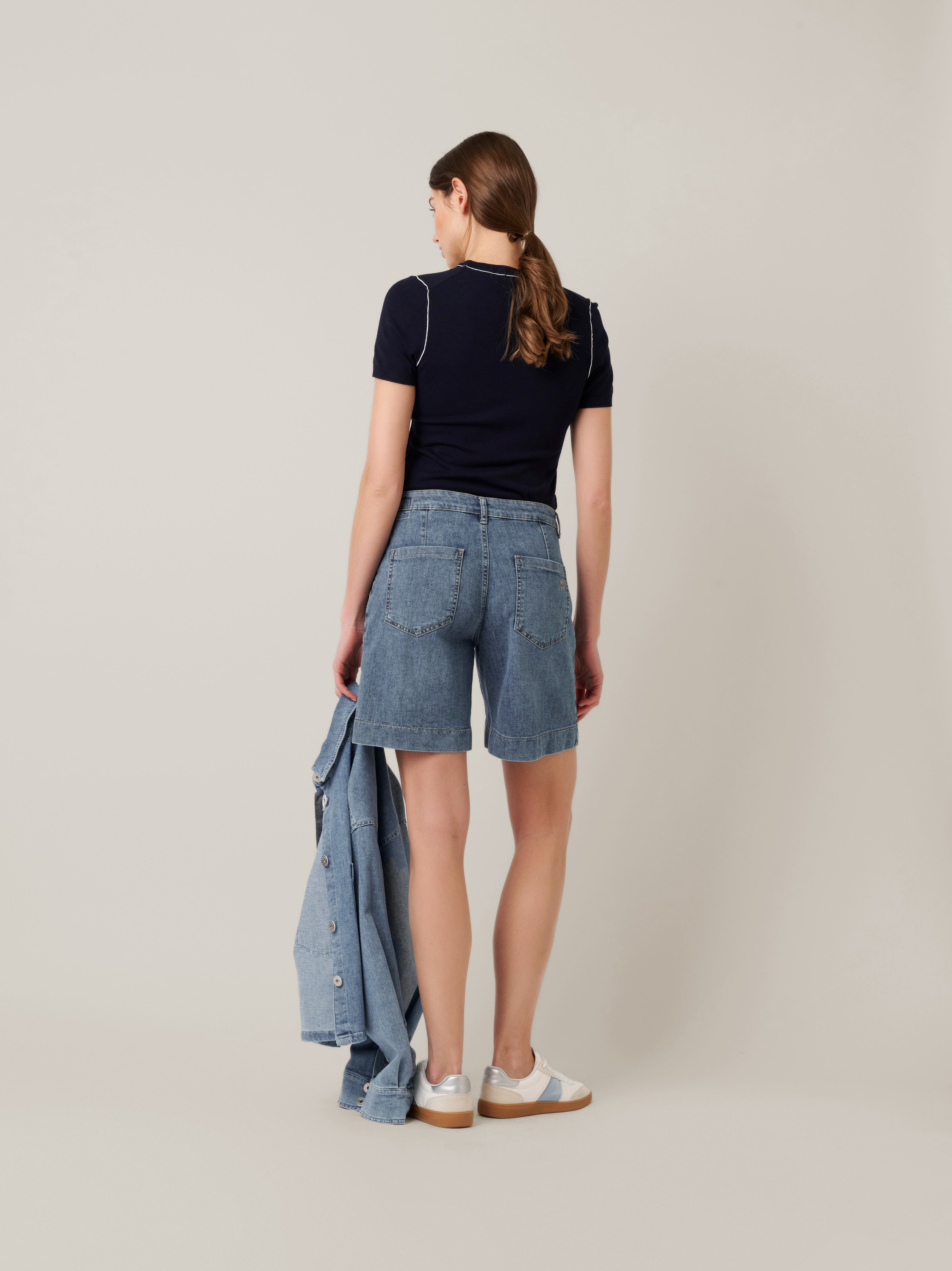 Womens shorts Mara Shorts in mid blue, denim shorts with framed pockets, back view worn by model