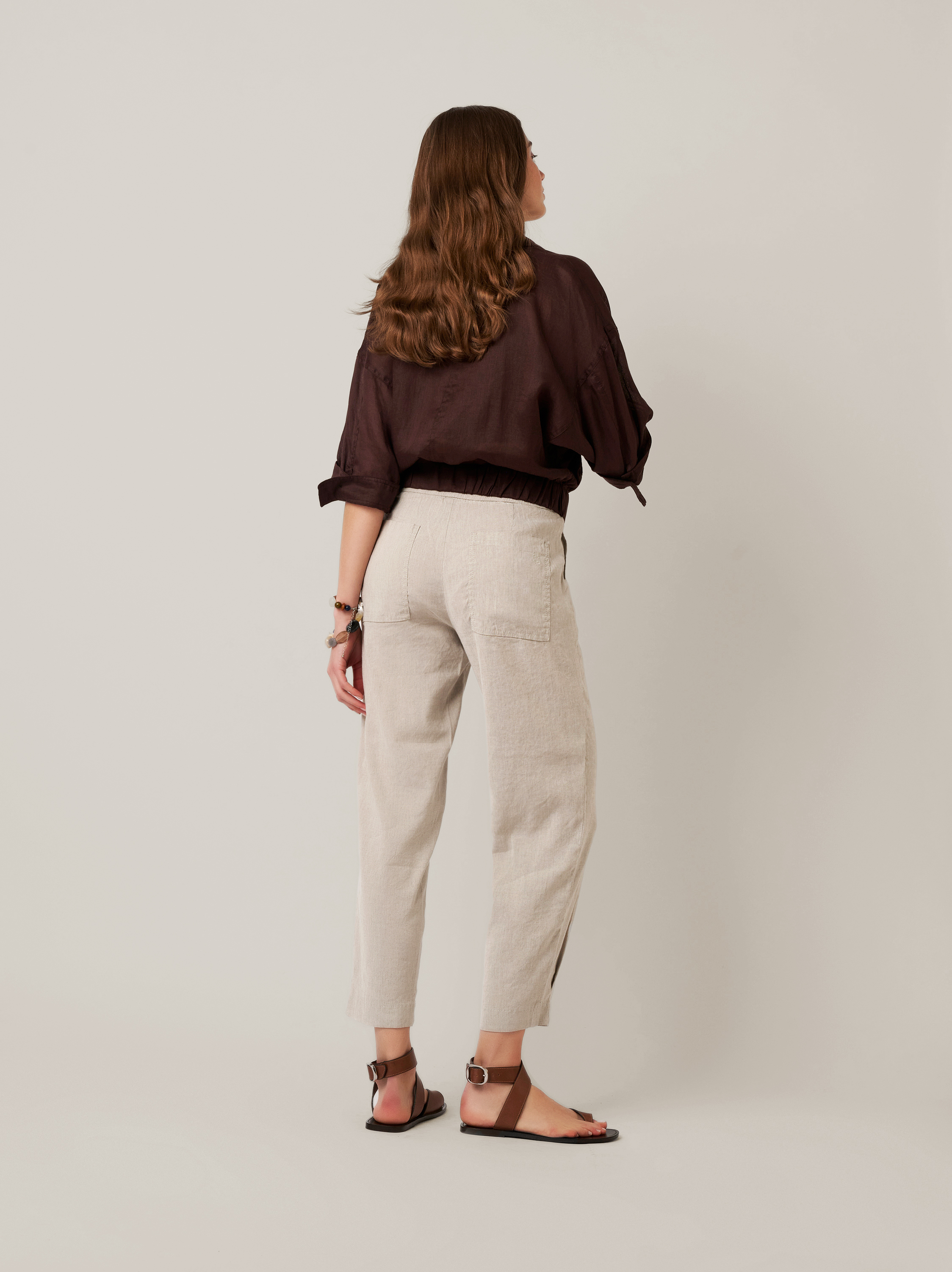 Womens trousers Mara Tapered in grey, tapered-fit trousers made of linen, back view worn by model