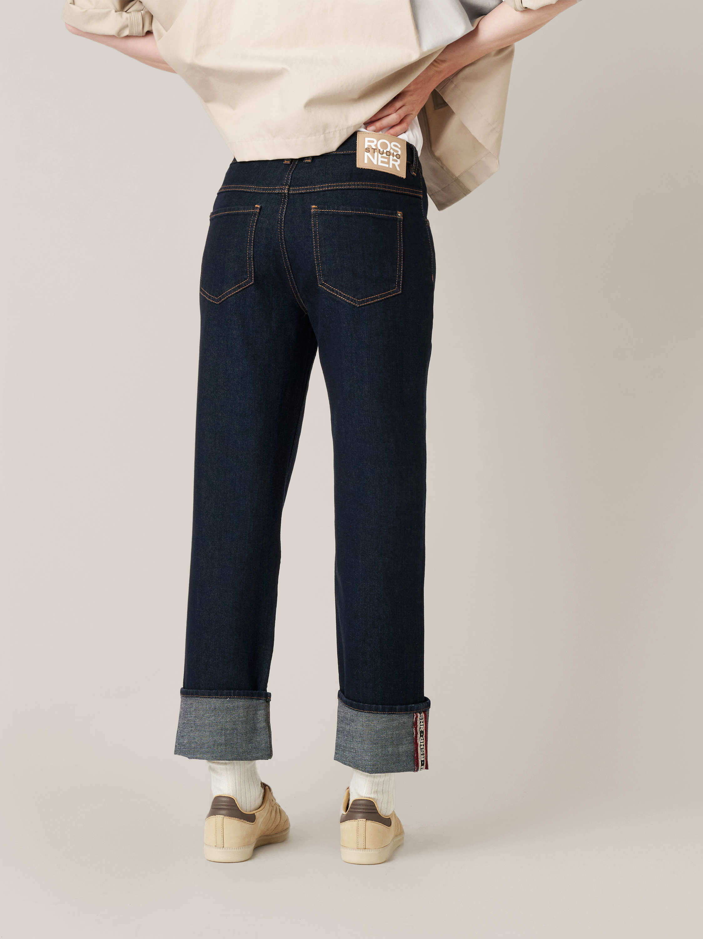 Womens jeans Masha_152 in dark blue, turn-up jeans with front seams, back view worn by model