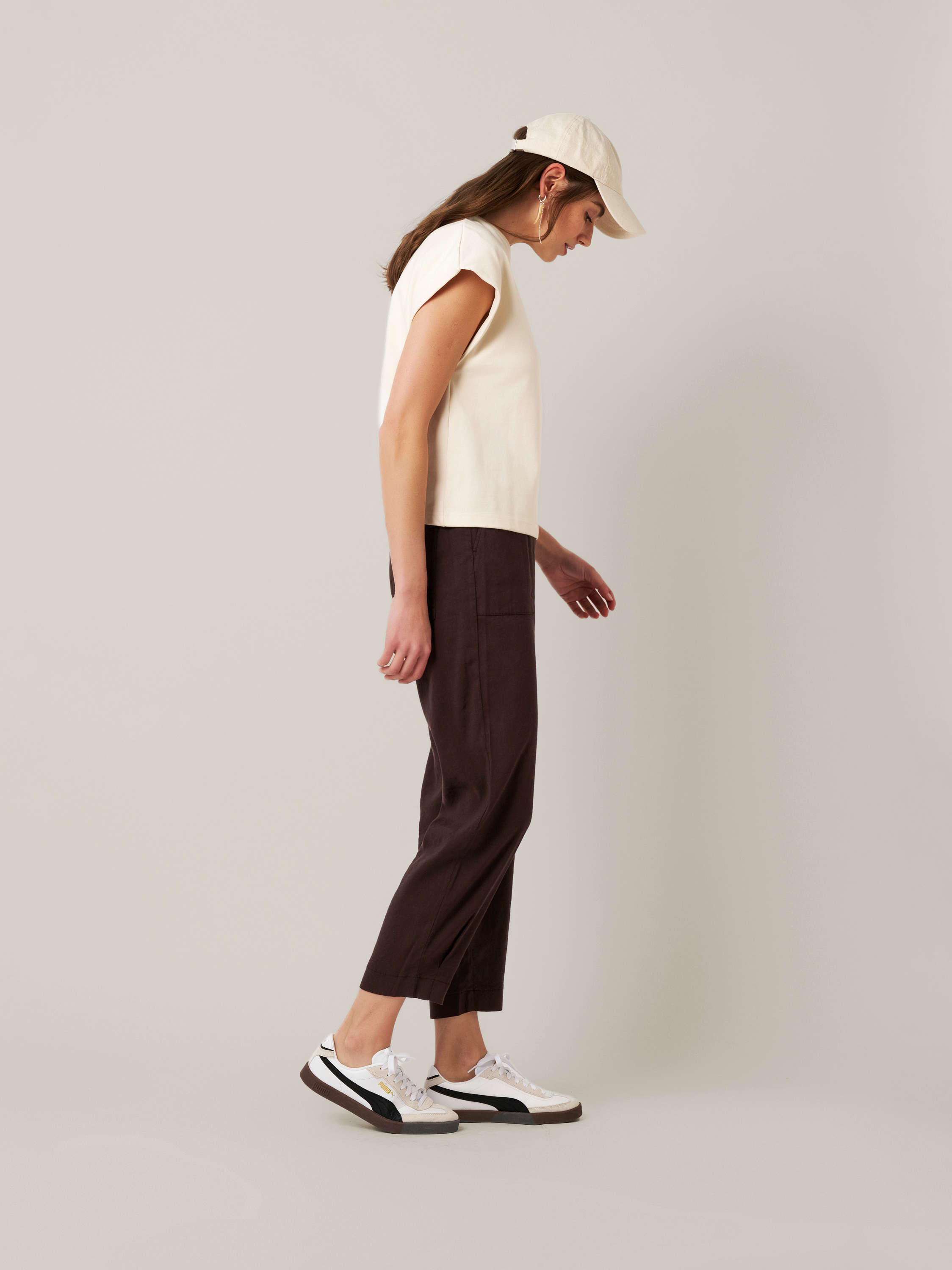 Womens trousers Mara Tapered in dark brown, tapered-fit trousers made of linen, front view worn by model