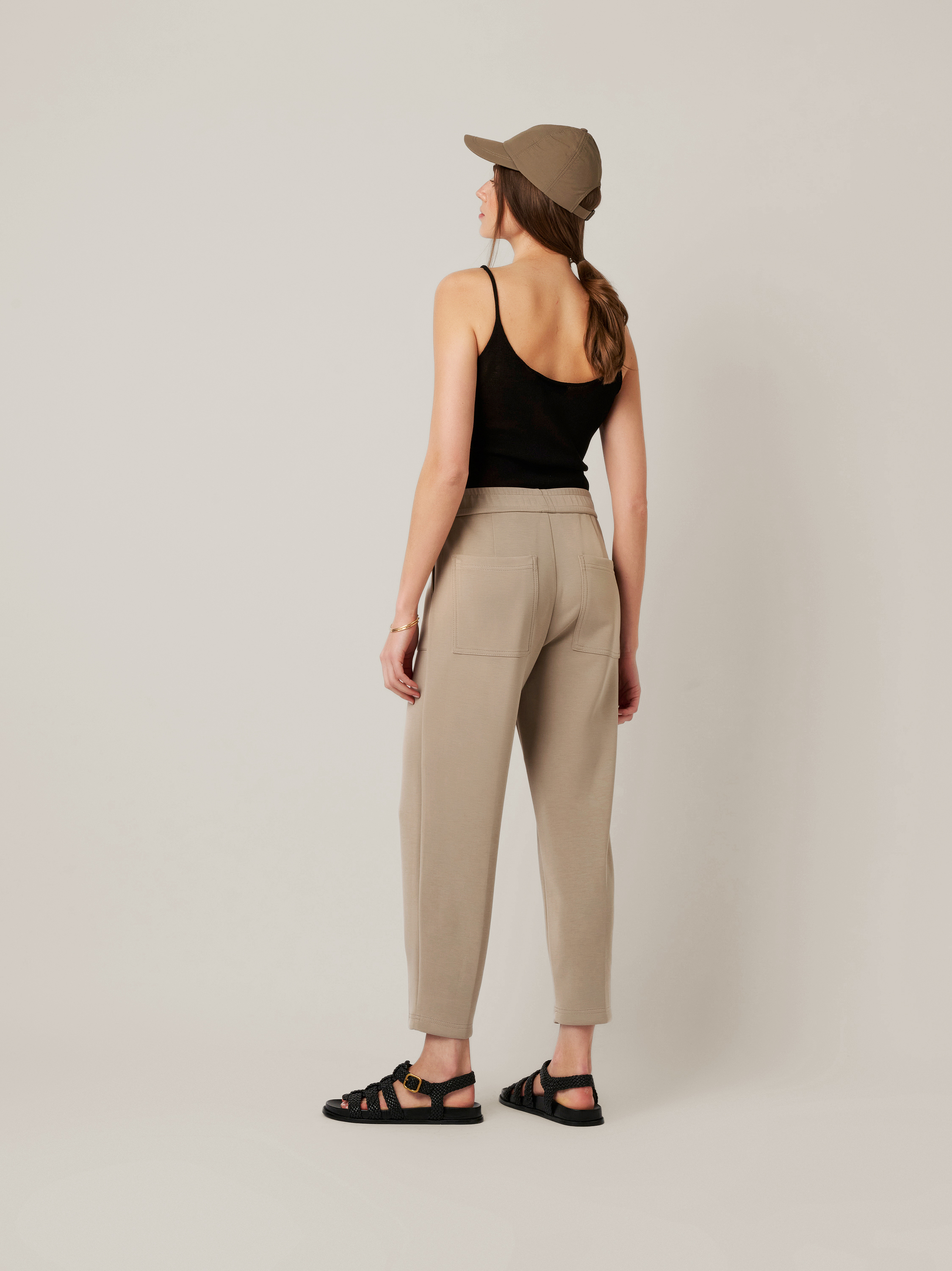 Womens trousers Mara Tapered in taupe, tapered-fit trousers made of scuba, back view worn by model