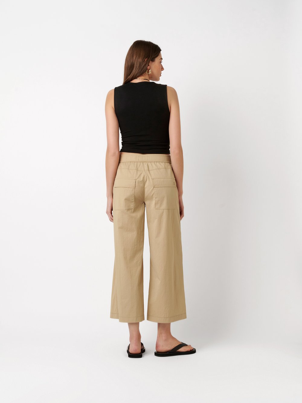 Womens trousers Mara Culotte in sand, culottes made of papertouch cotton, back view worn by model