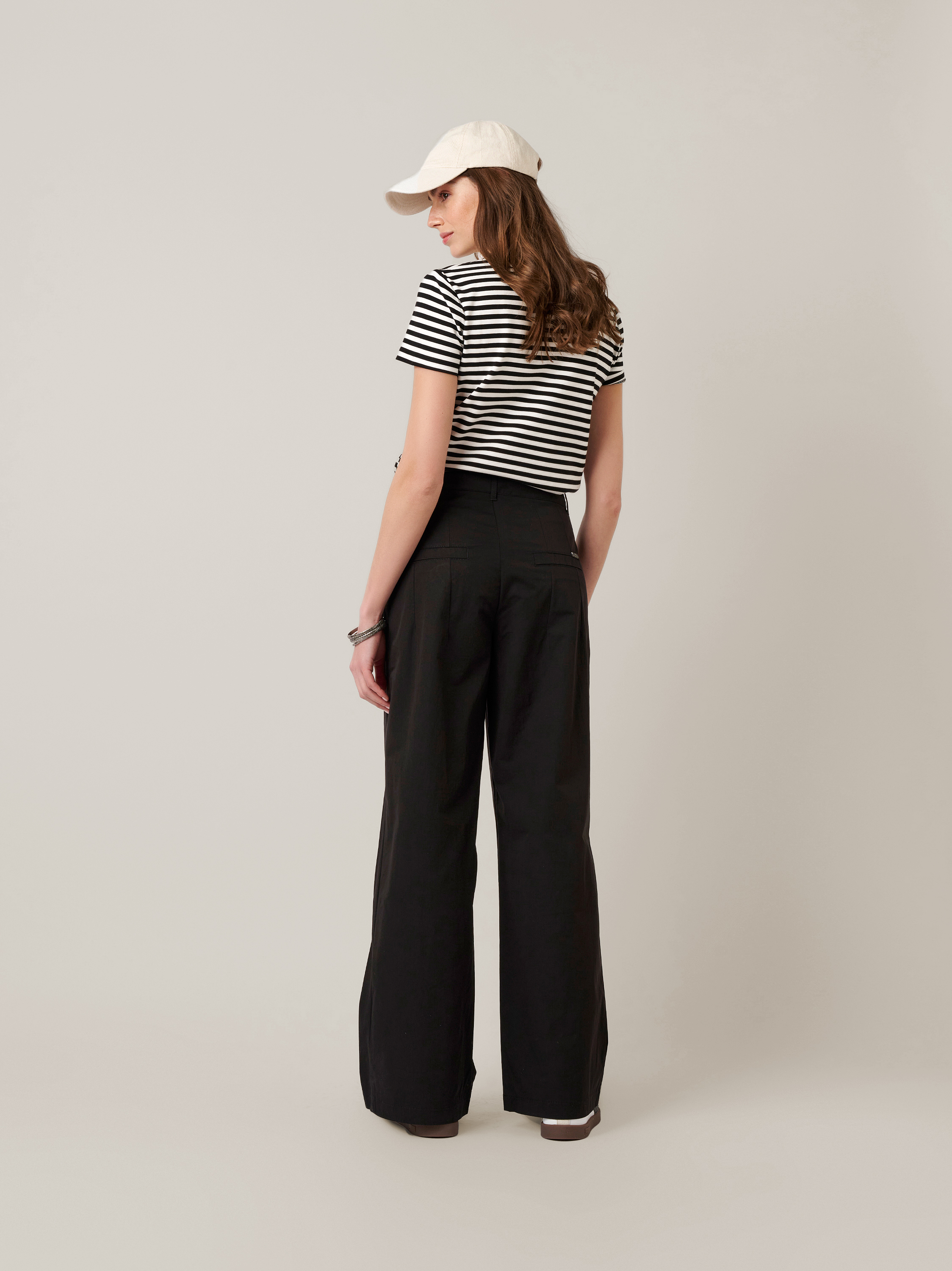 Womens trousers Mara Wide in black, wide-leg trousers made of papertouch cotton, back view worn by model