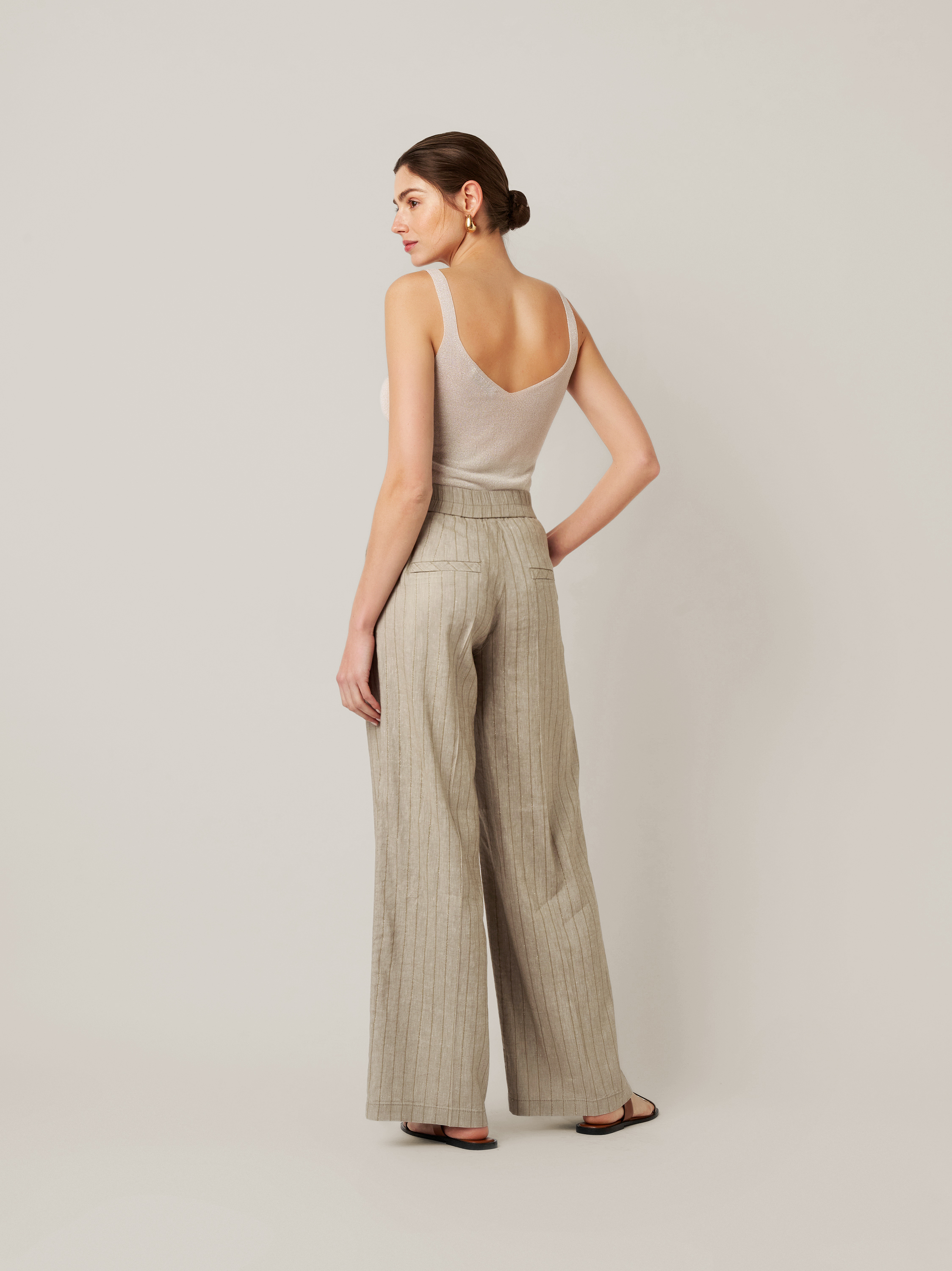 Womens trousers Mara Wide in khaki / gold, linen trousers with subtly shimmering stripes, back view worn by model