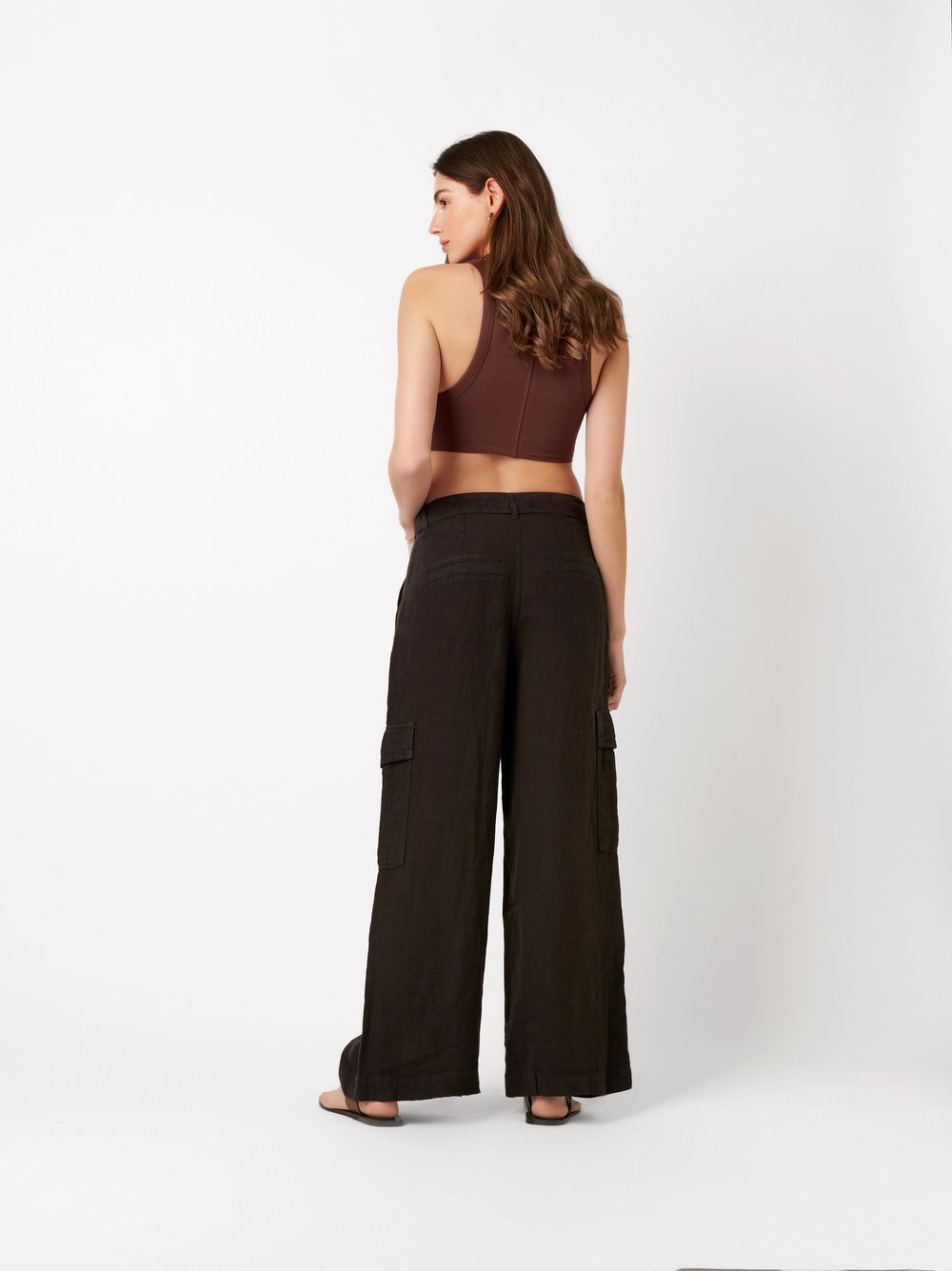 Womens trousers Mara Wide in dark brown, wide-leg linen trousers with cargo pockets and tie, back view worn by model