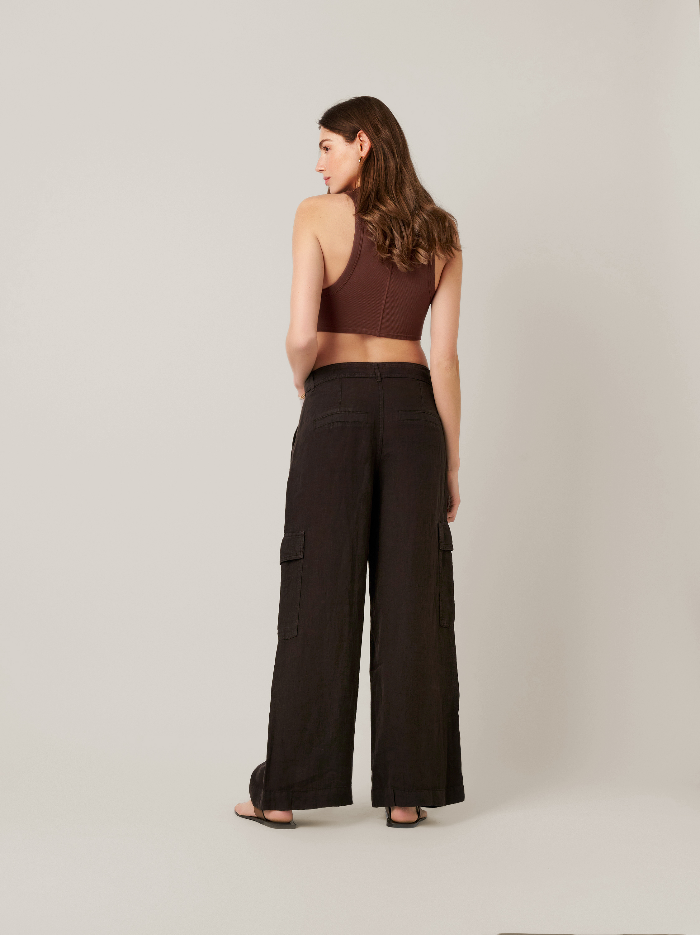 Womens trousers Mara Wide in dark brown, wide-leg linen trousers with cargo pockets and tie, back view worn by model
