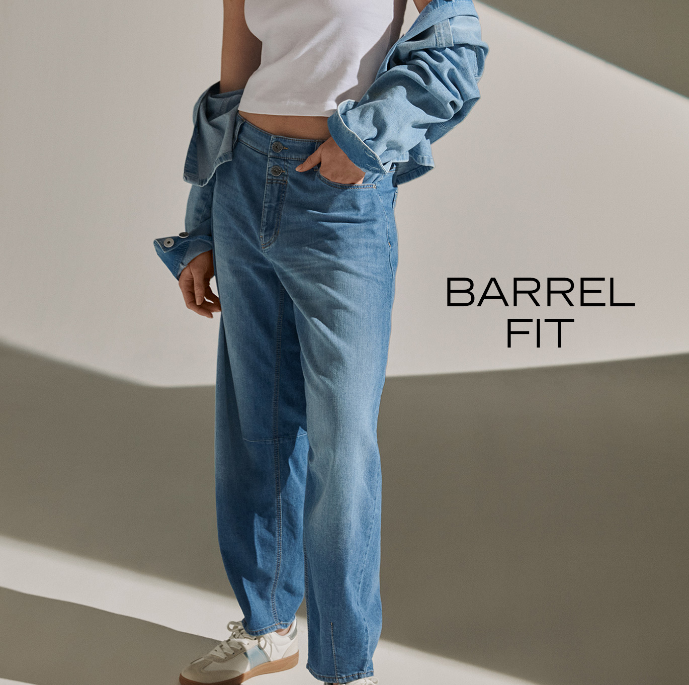 Model wearing barrel-fit jeans with a white top and denim shirt – teaser for the ROSNER Barrel Fit category