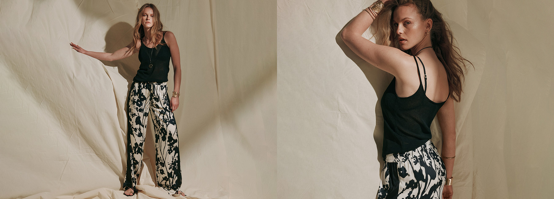 Model wearing a black top and wide-leg trousers with a floral print against a studio backdrop – teaser for all Rosner Studio looks