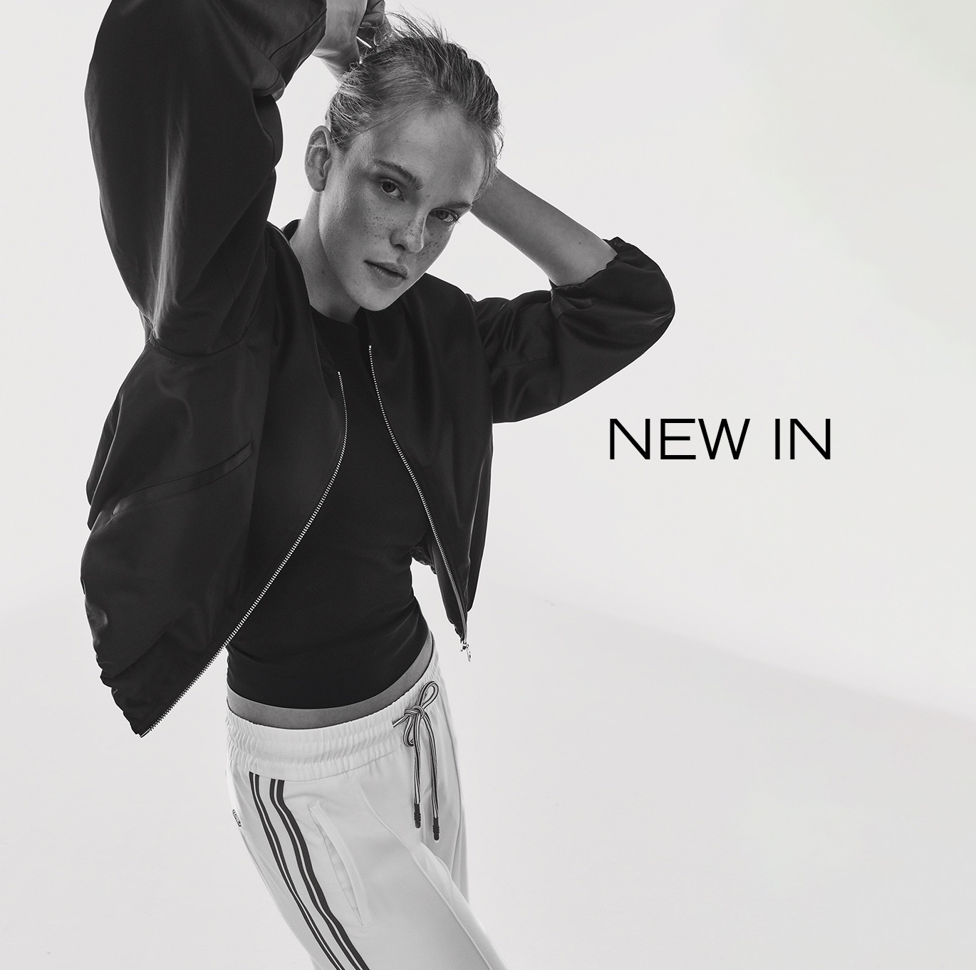 Black and white image of a model wearing a bomber jacket and track pants – teaser for Rosner New